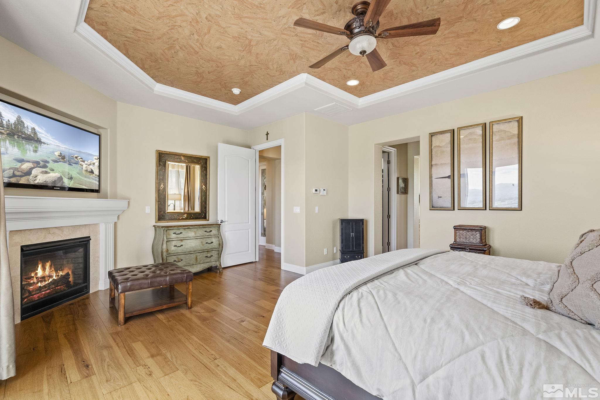 2892 Promontory Drive Genoa, NV 89411 - Photo 23 of 40 a spacious bedroom with a bed and a fireplace
