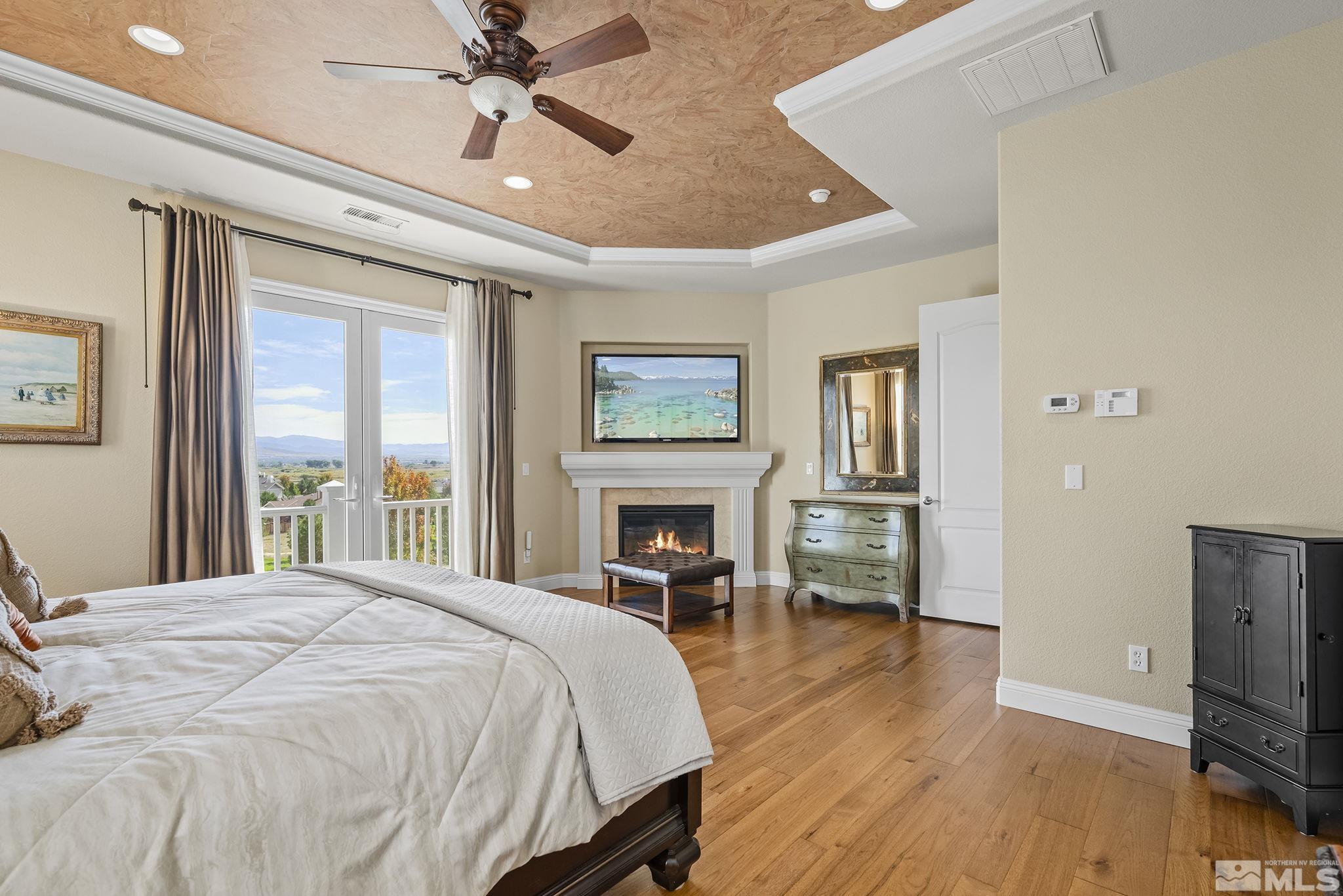 2892 Promontory Drive Genoa, NV 89411 - Photo 24 of 40 a spacious bedroom with a bed and a fireplace