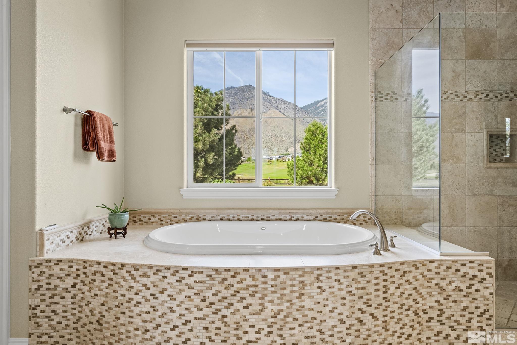 2892 Promontory Drive Genoa, NV 89411 - Photo 25 of 40 a bathroom with a bathtub and shower