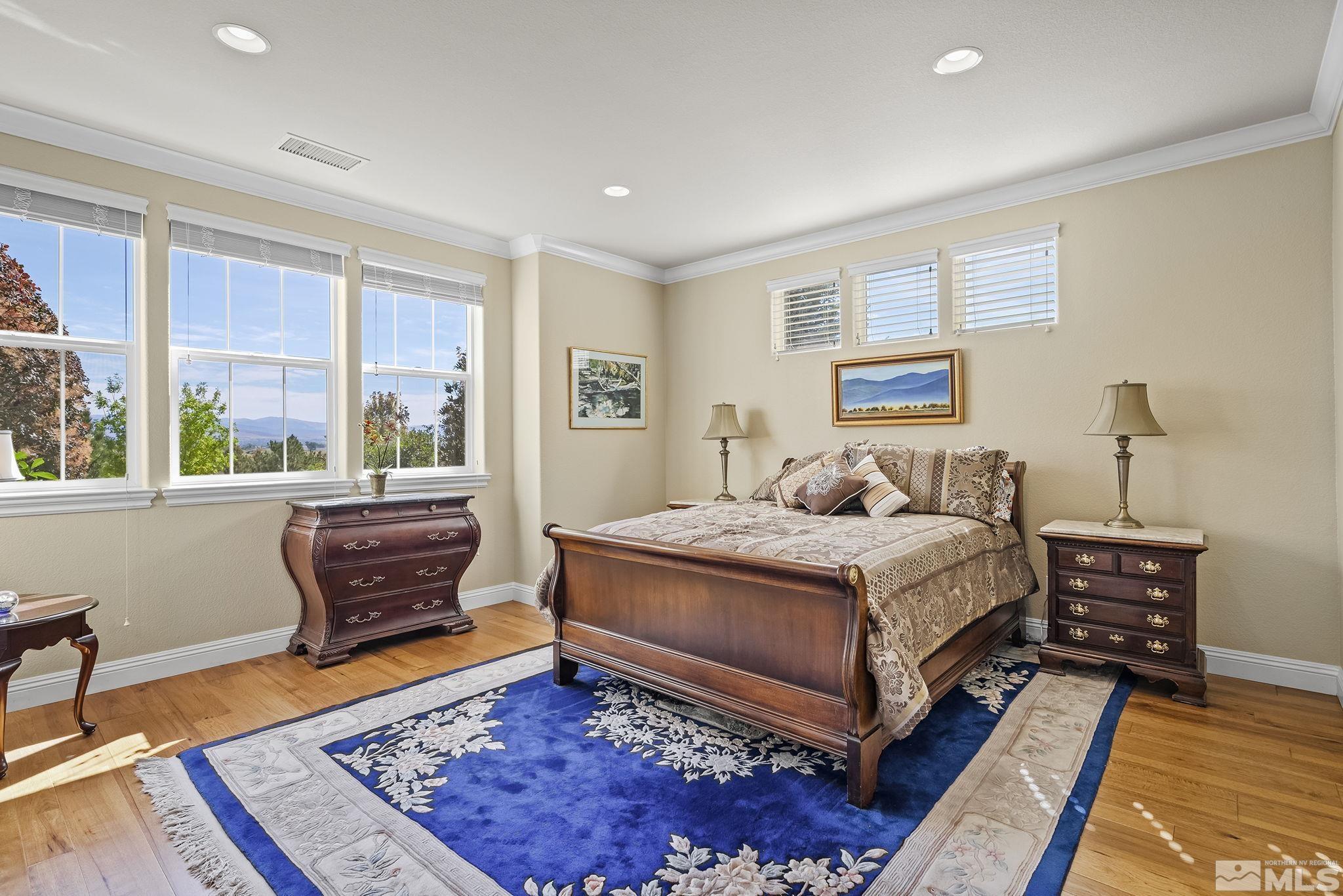 2892 Promontory Drive Genoa, NV 89411 - Photo 28 of 40 a bedroom with a bed and wooden floor