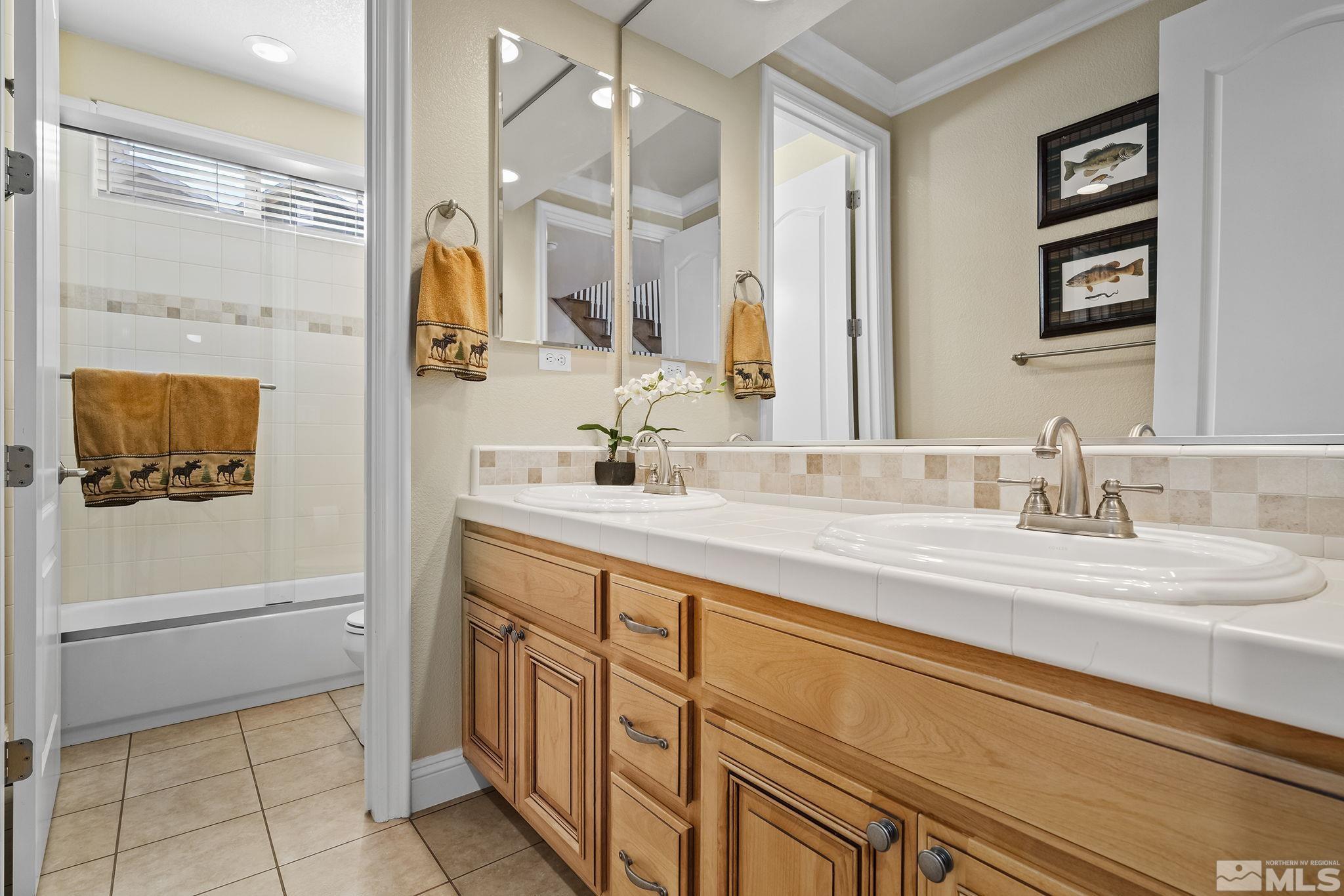 2892 Promontory Drive Genoa, NV 89411 - Photo 29 of 40 a bathroom with a sink a vanity and a mirror