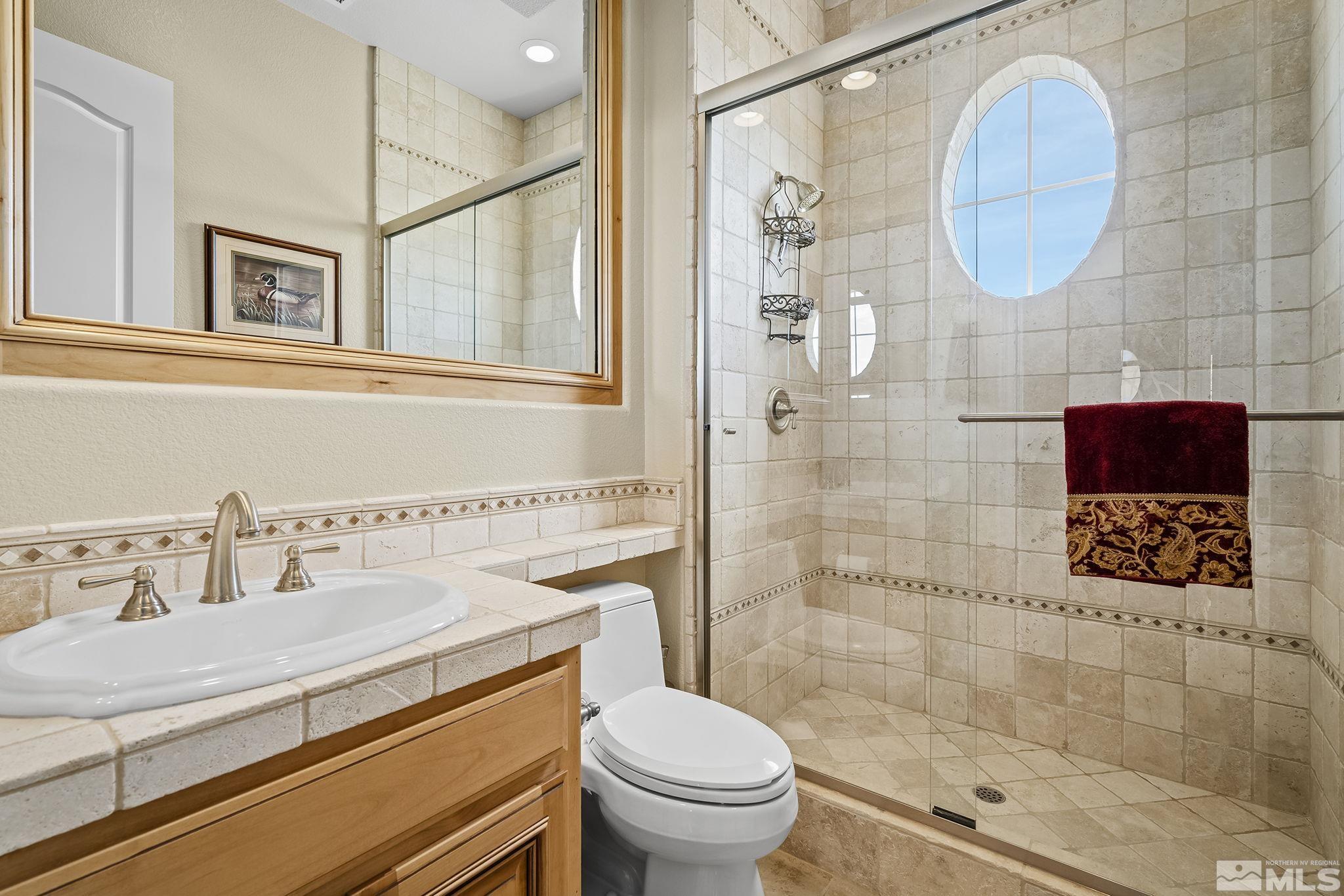 2892 Promontory Drive Genoa, NV 89411 - Photo 30 of 40 a bathroom with a sink a toilet and shower