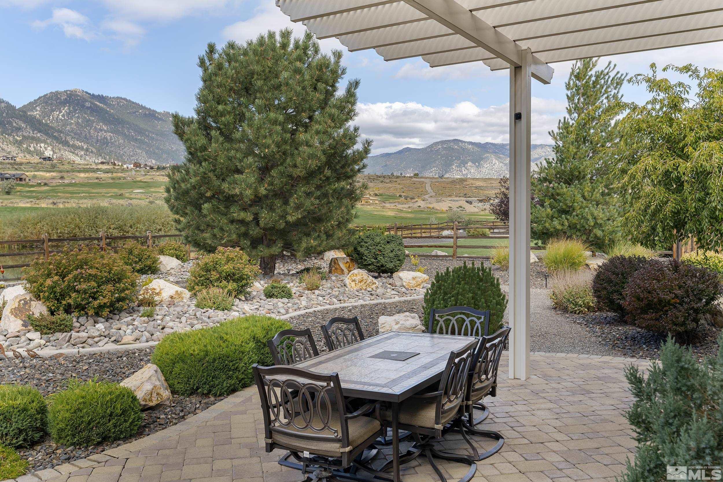 2892 Promontory Drive Genoa, NV 89411 - Photo 32 of 40 a view of a balcony with table and chairs and potted plants
