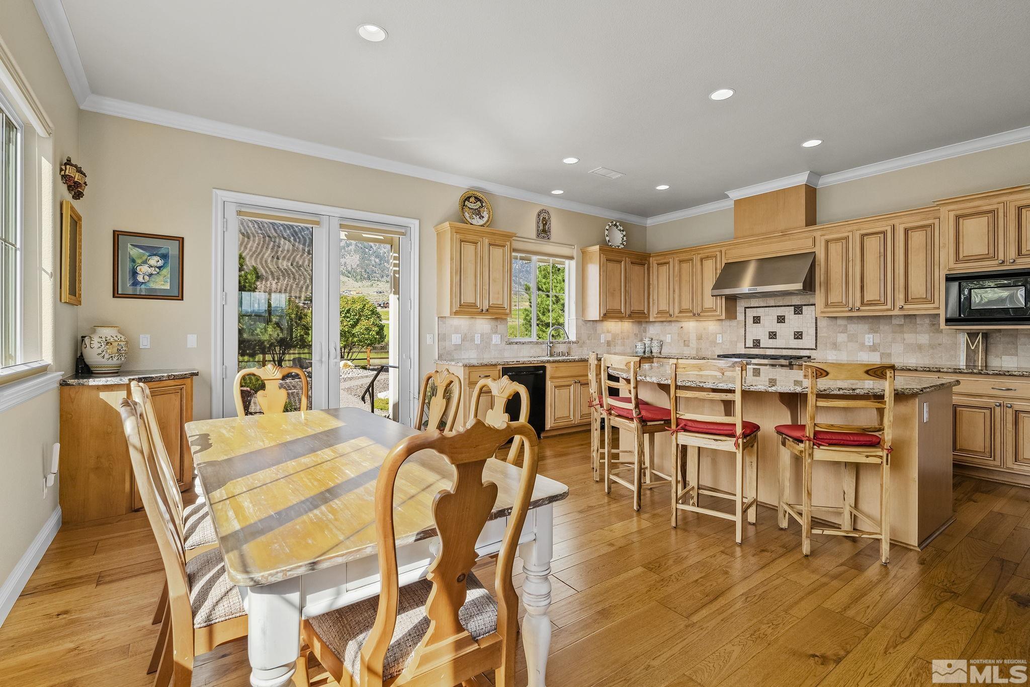 2892 Promontory Drive Genoa, NV 89411 - Photo 10 of 40 a living room with stainless steel appliances kitchen island granite countertop furniture and a large window