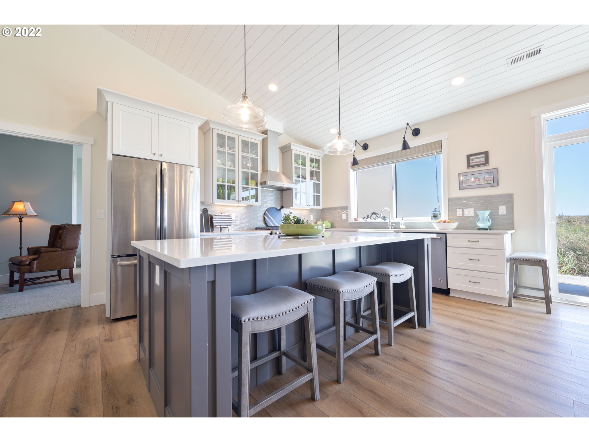 89442 Ocean Drive Warrenton, OR 97146 - Photo 25 of 31 a open dining room with stainless steel appliances kitchen island granite countertop a table chairs and a refrigerator