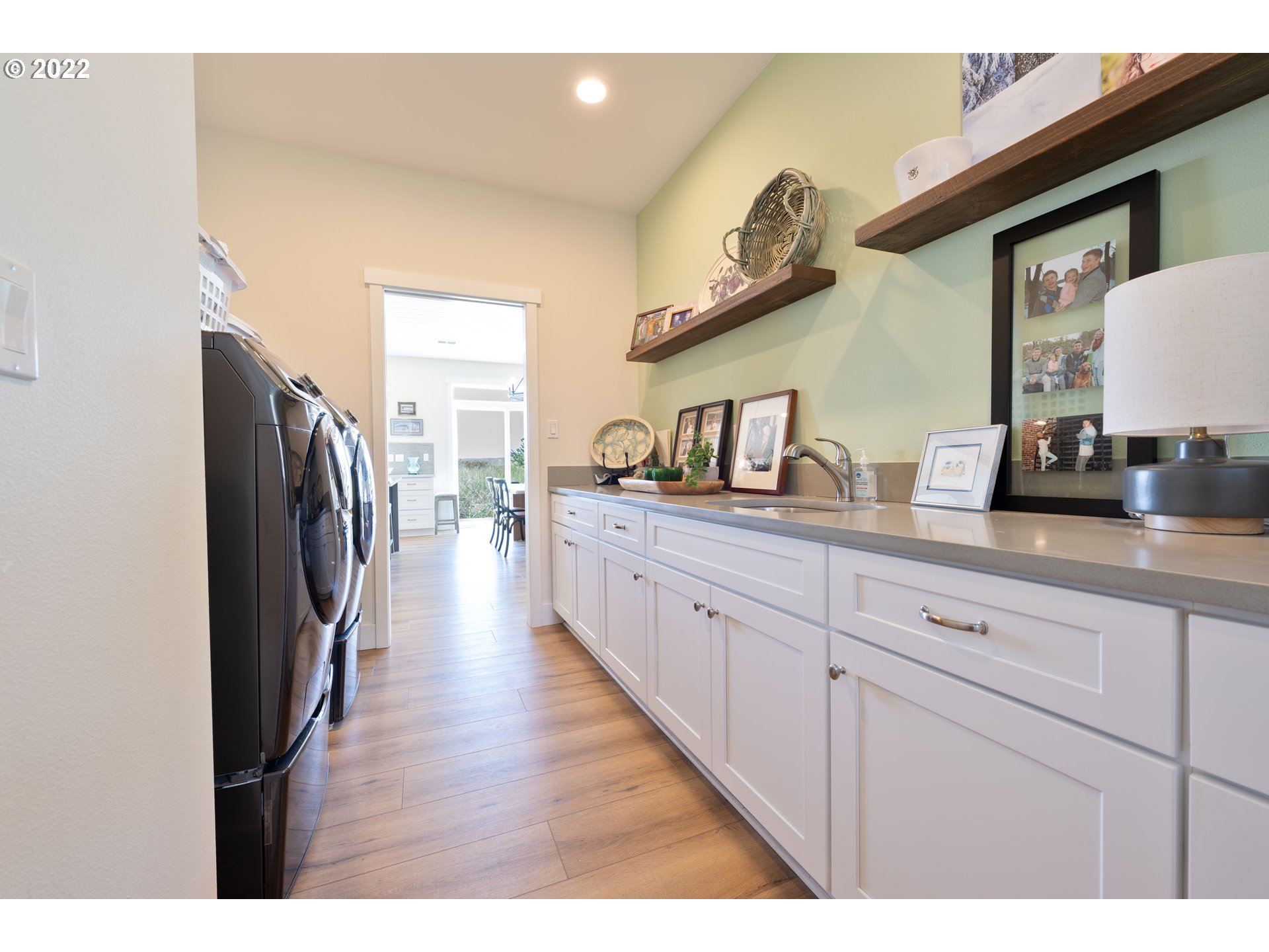89442 Ocean Drive Warrenton, OR 97146 - Photo 26 of 31 a kitchen with cabinets a sink and a wooden floor
