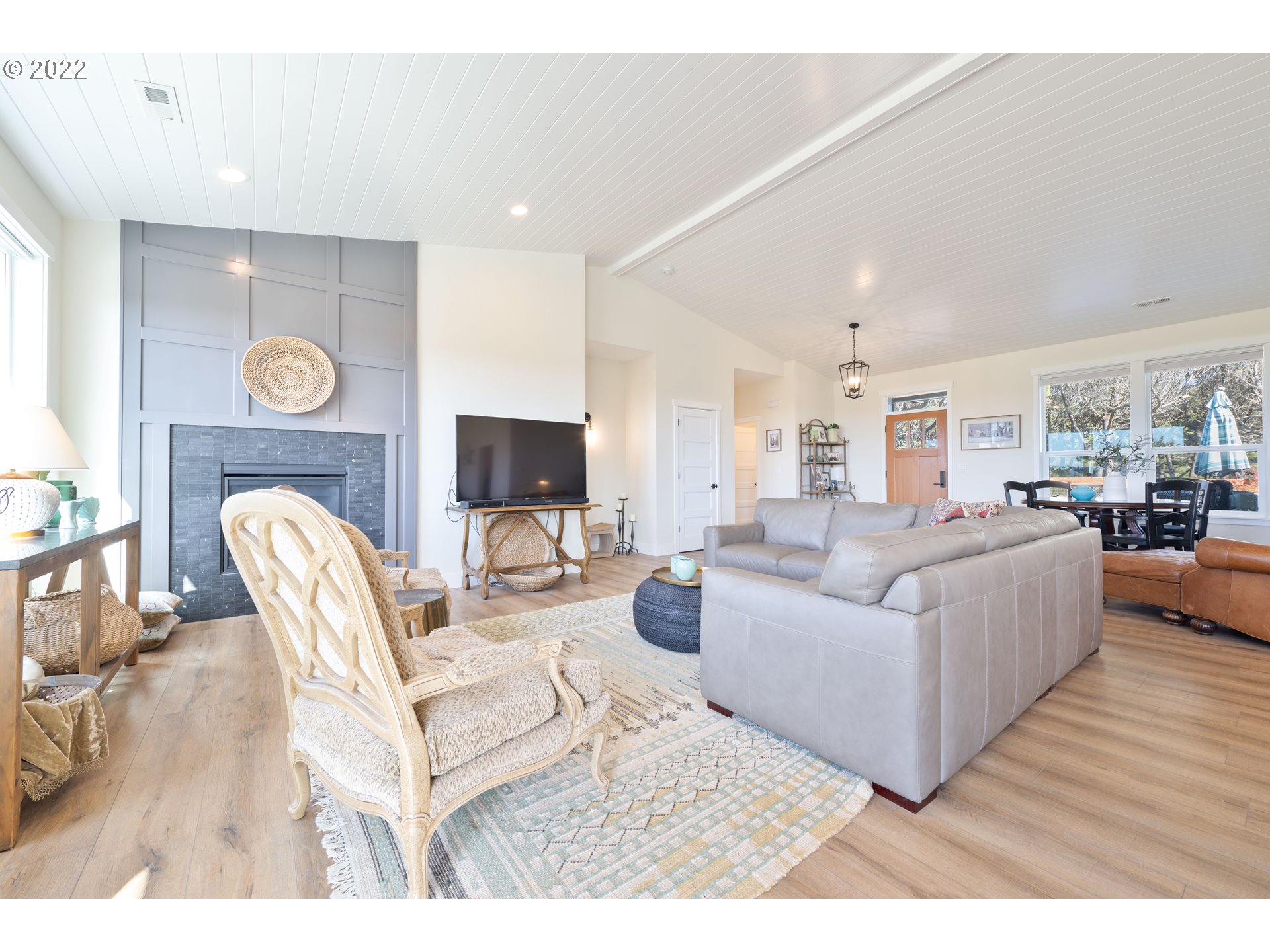 89442 Ocean Drive Warrenton, OR 97146 - Photo 28 of 31 a living room with furniture a fireplace and a flat screen tv