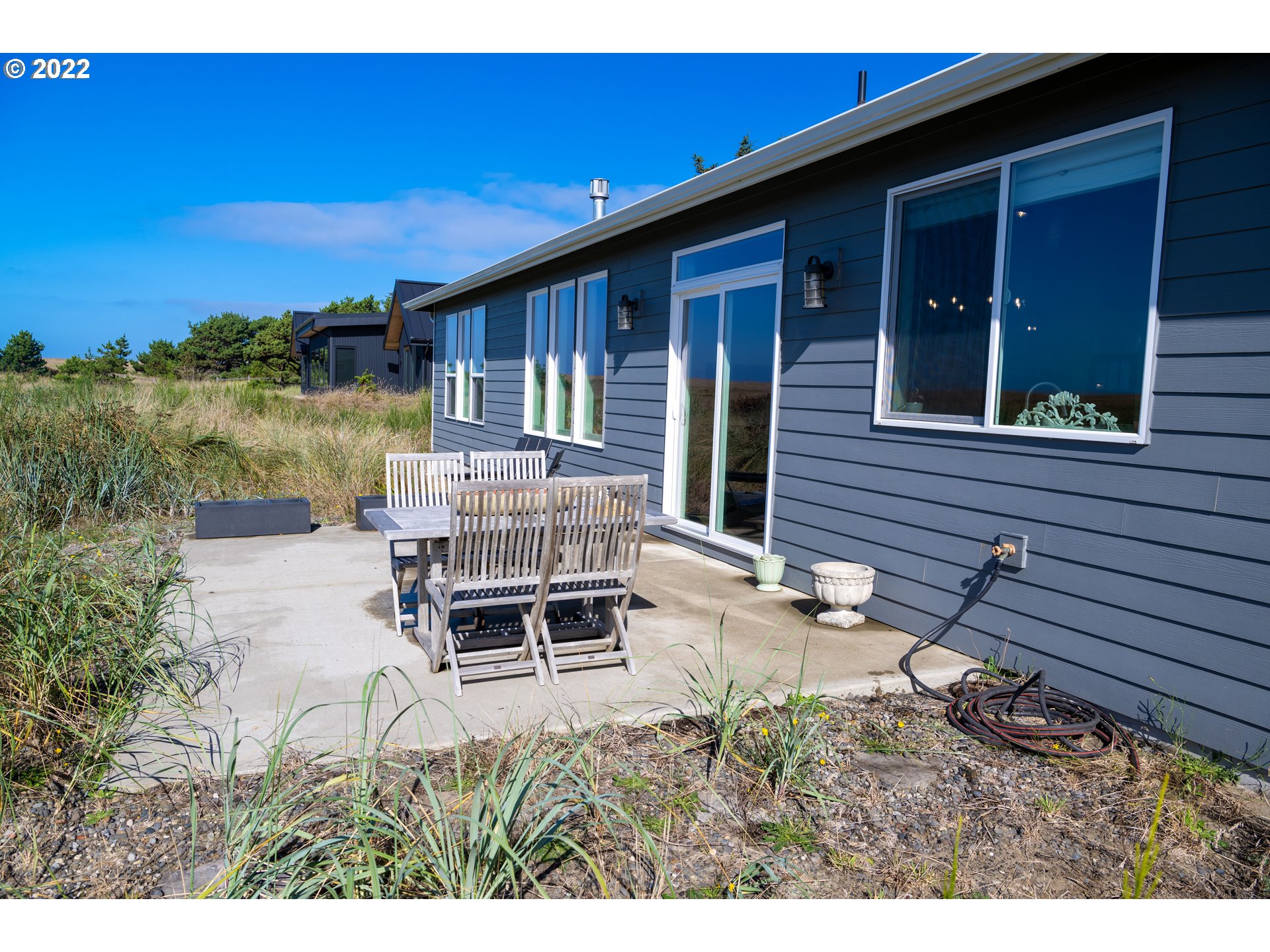 89442 Ocean Drive Warrenton, OR 97146 - Photo 3 of 31 a backyard of a house with outdoor seating