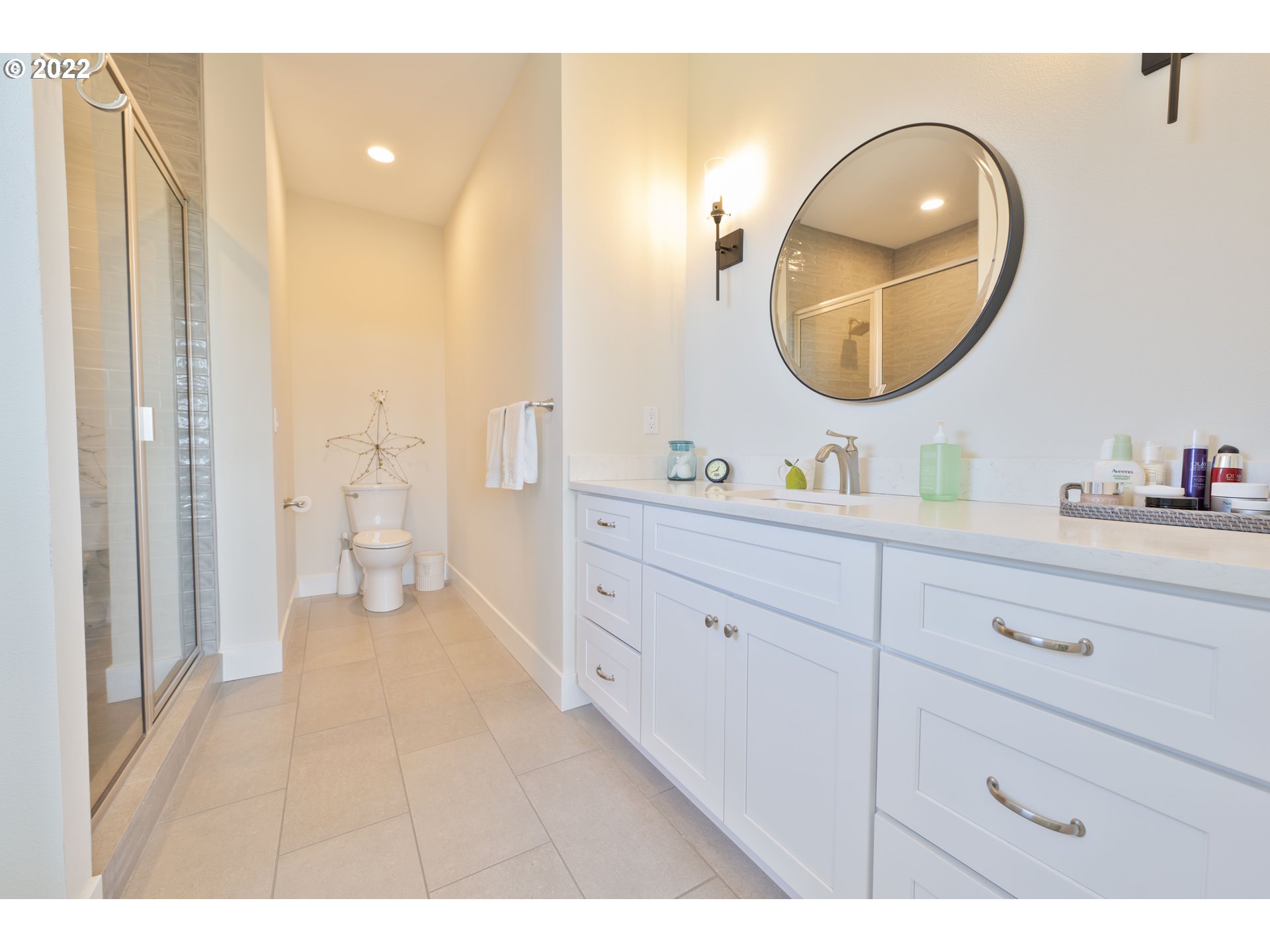 89442 Ocean Drive Warrenton, OR 97146 - Photo 6 of 31 a en suite bathroom with a double vanity sink a mirror and a shower
