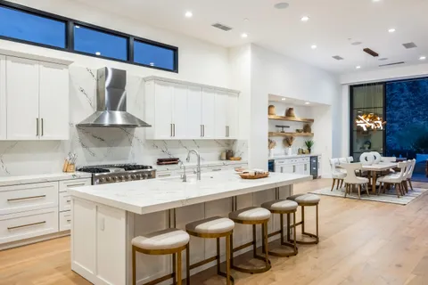 a living room with furniture wooden floor and a large window