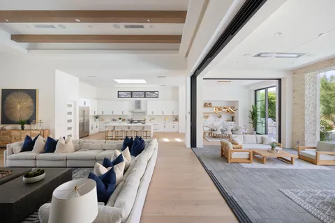 a living room with furniture a rug and a large window