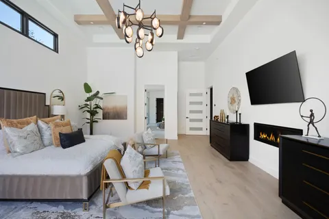 a bedroom with furniture and a large window