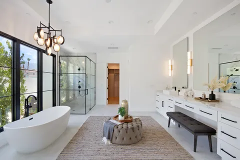 a bedroom with a bed and a flat tv screen on dresser