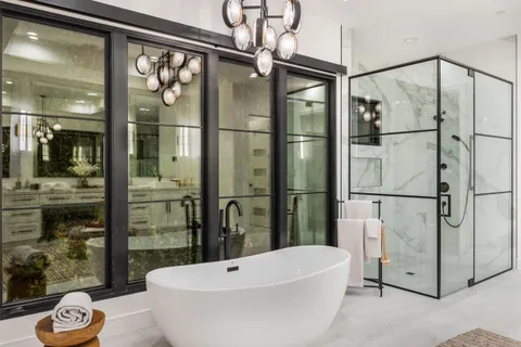 a large living room with stainless steel appliances a chandelier