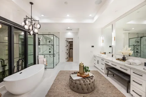 a large room with kitchen island a sink and a refrigerator