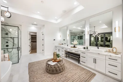 a bedroom with a bed a mirror and dresser