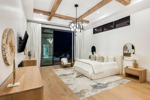 a front view of a house with a yard and potted plants