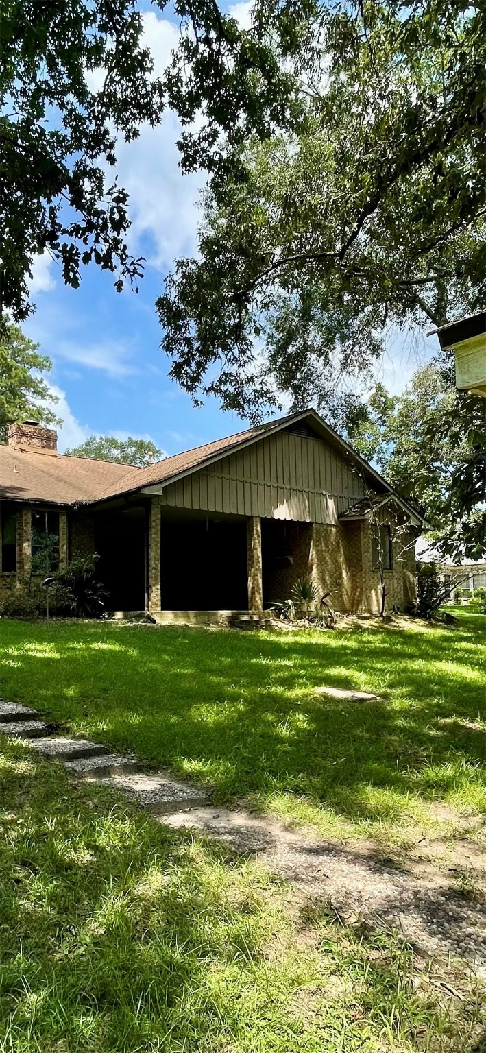 10074 Overbrook Drive Conroe, TX 77304 - Photo 21 of 22 a front view of a house with a garden