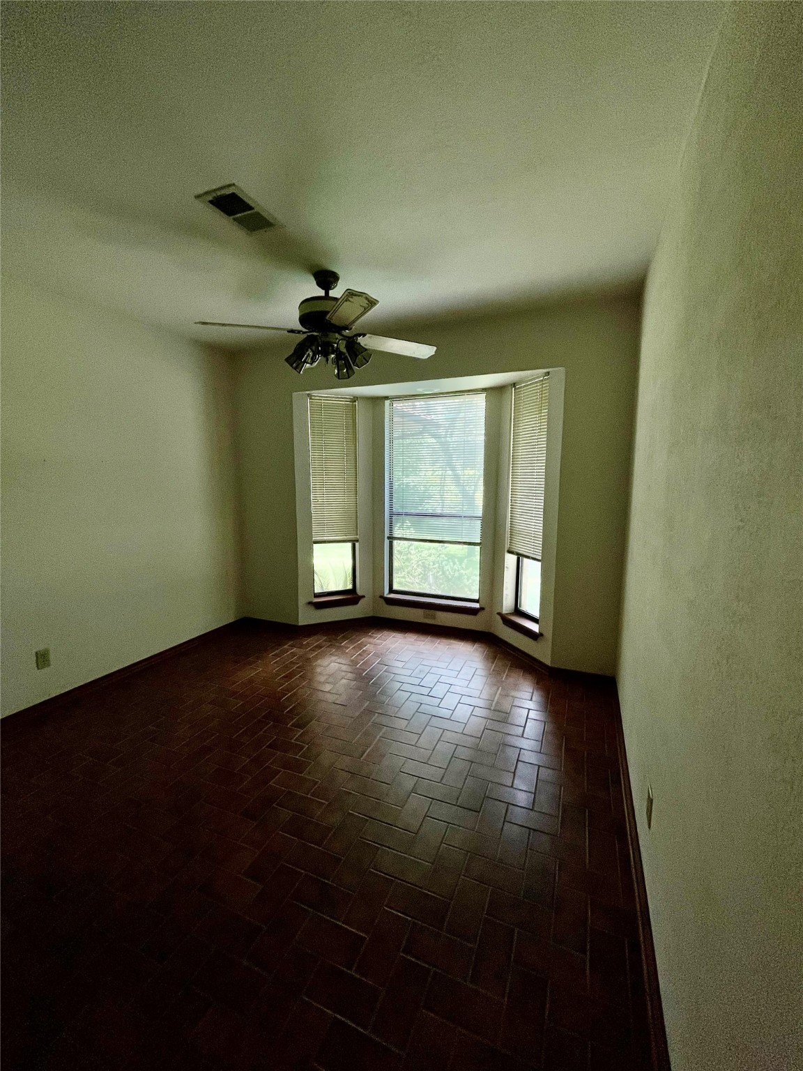 10074 Overbrook Drive Conroe, TX 77304 - Photo 8 of 22 an empty room with windows and fan