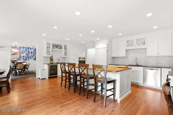 16 Pierce Road Riverside, CT 06878 - Photo 6 of 36 a kitchen with stainless steel appliances granite countertop dining table chairs and wooden floor