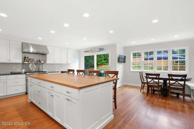 16 Pierce Road Riverside, CT 06878 - Photo 8 of 36 a large kitchen with kitchen island a dining table and chairs