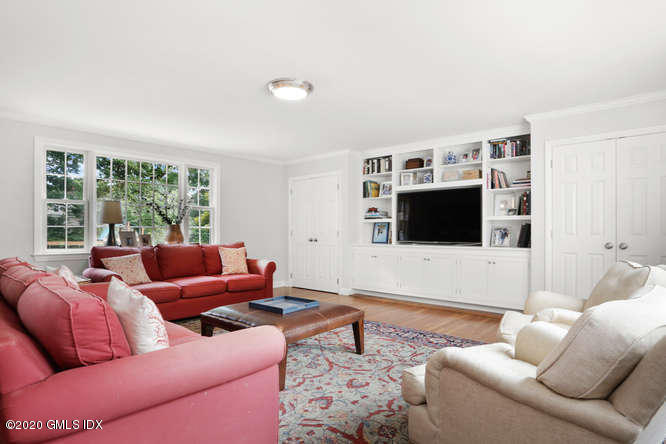 16 Pierce Road Riverside, CT 06878 - Photo 10 of 36 a living room with furniture a flat screen tv and a floor to ceiling window