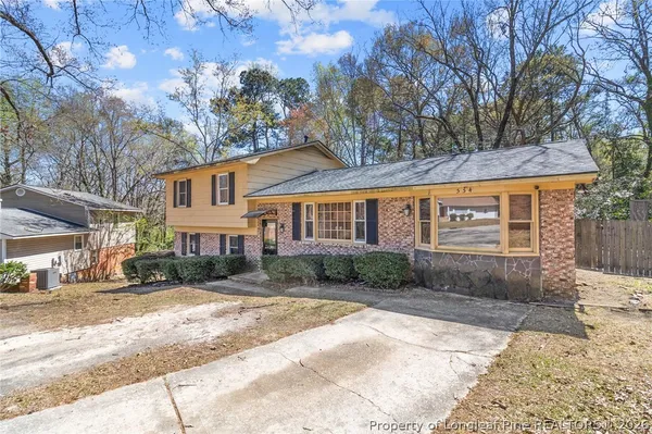 a view of a hallway with wooden floor and stairs