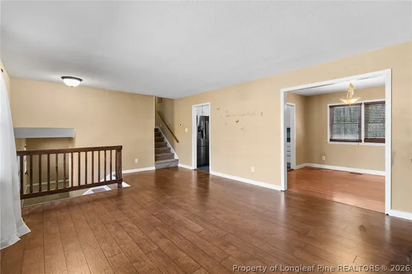 an empty room with windows and cabinet