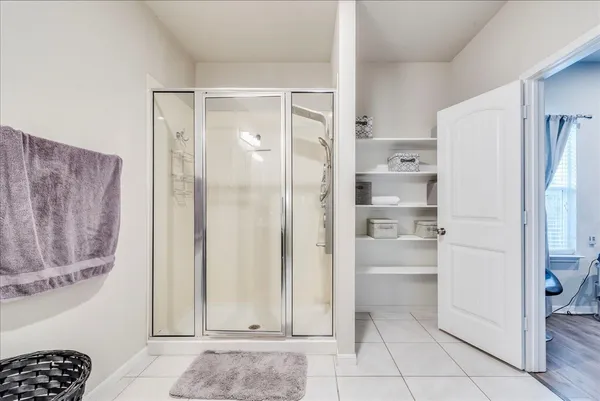a view of a kitchen with a refrigerator and cabinets
