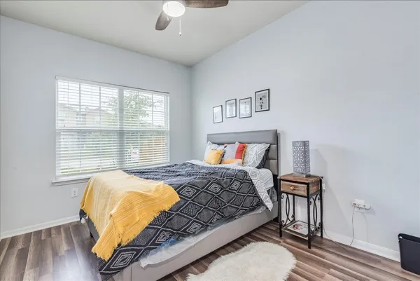 a bedroom with a bed and wooden floor