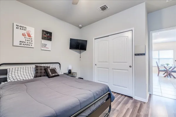 a bedroom with a bed and a flat screen tv