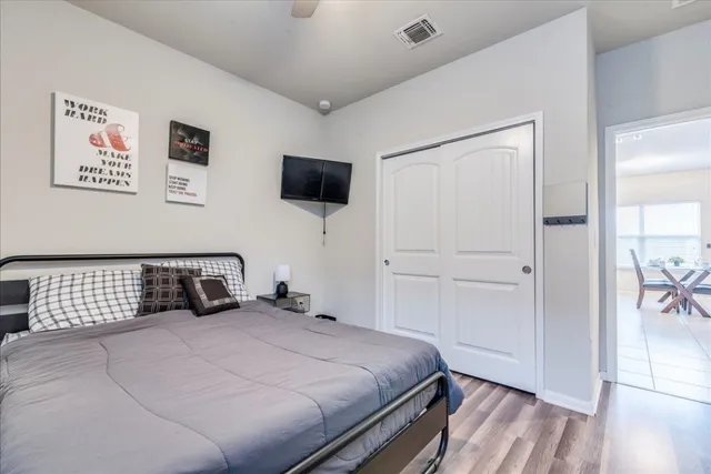 a bedroom with a bed and a flat screen tv