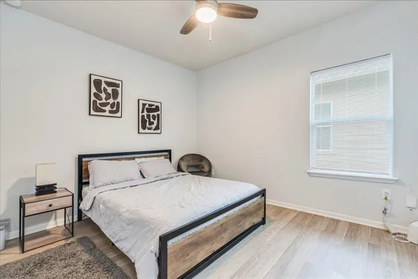 a bedroom with a bed and a chandelier