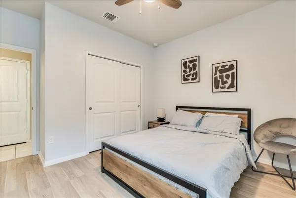 a bedroom with a bed and a chandelier