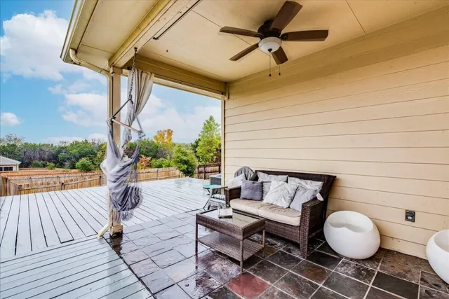 a balcony with wooden floor and a potted plant
