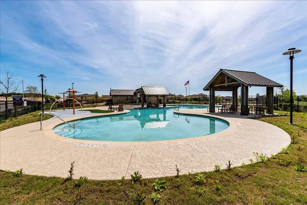 a view of a swimming pool with an outdoor seating