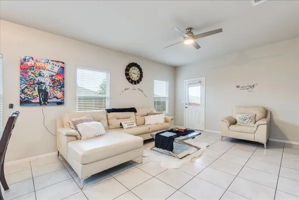 a living room with furniture and a clock