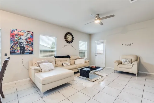 a living room with furniture and a clock