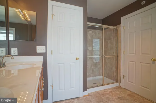 a bathroom with a shower and a sink