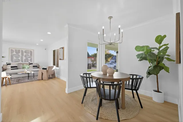 a view of a dining room with furniture and chandelier