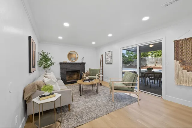 a living room with furniture kitchen view and a table