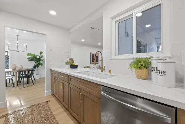 a kitchen with stainless steel appliances granite countertop a stove a sink and a refrigerator