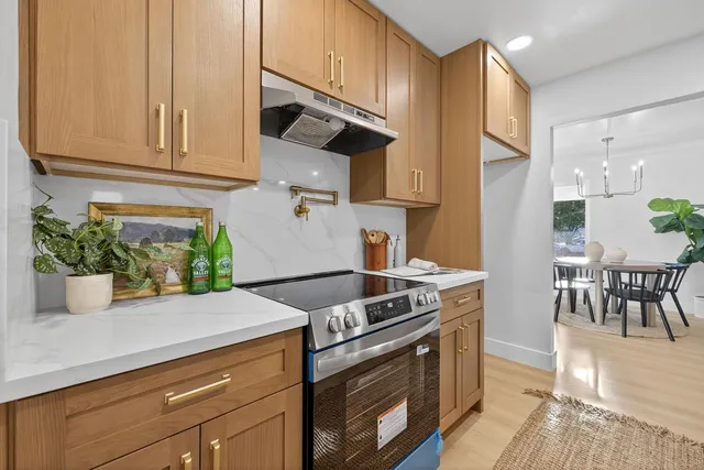 a spacious bathroom with a granite countertop sink a mirror and a shower