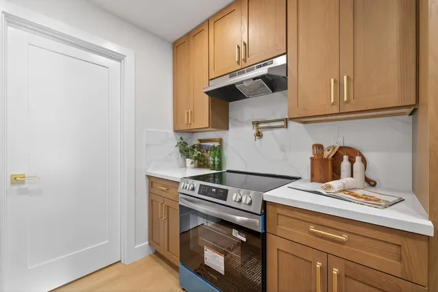 a kitchen with stainless steel appliances granite countertop a sink and stove top oven