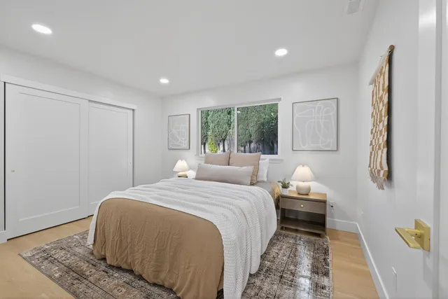 a spacious bedroom with a bed and a view of bathroom