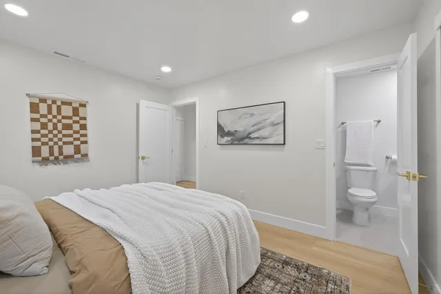 a bathroom with a toilet a sink and mirror