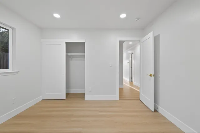 a backyard of a house with barbeque oven table and chairs