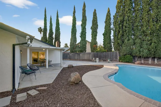 a view of a house with a backyard and garage