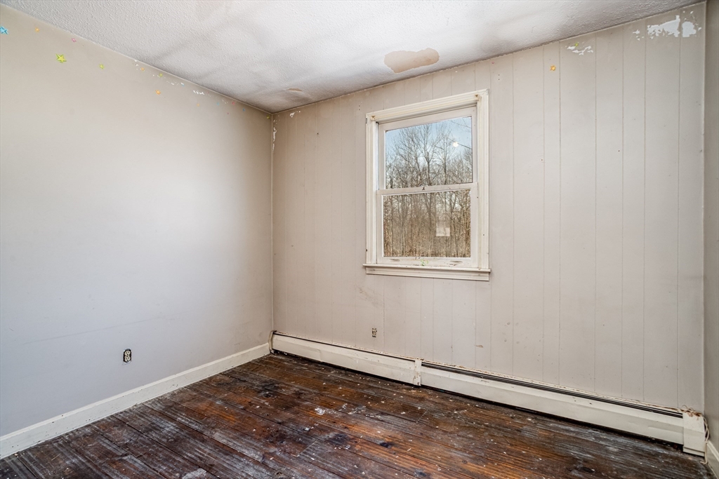21 Davis Road Westminster, MA 01473 - Photo 10 of 26 a view of an empty room with wooden floor and a window