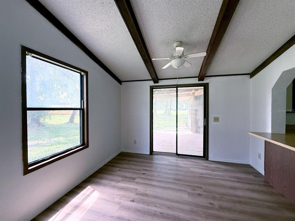 33248 Ridge Manor Boulevard Dade City, FL 33523 - Photo 13 of 20 an empty room with wooden floor and windows